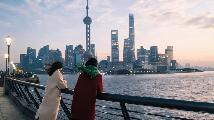 Travellers on the Shanghai riverside at dusk during a visa-free transit stay