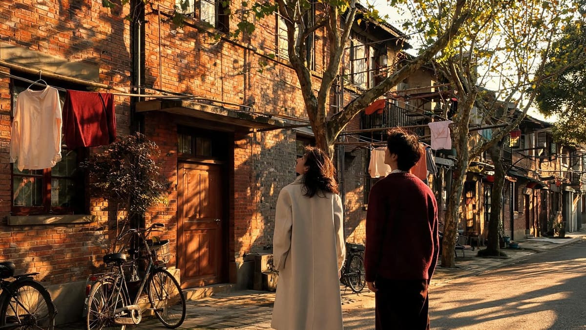 Renting in Shanghai: a couple looking up at an apartment building in a lane
