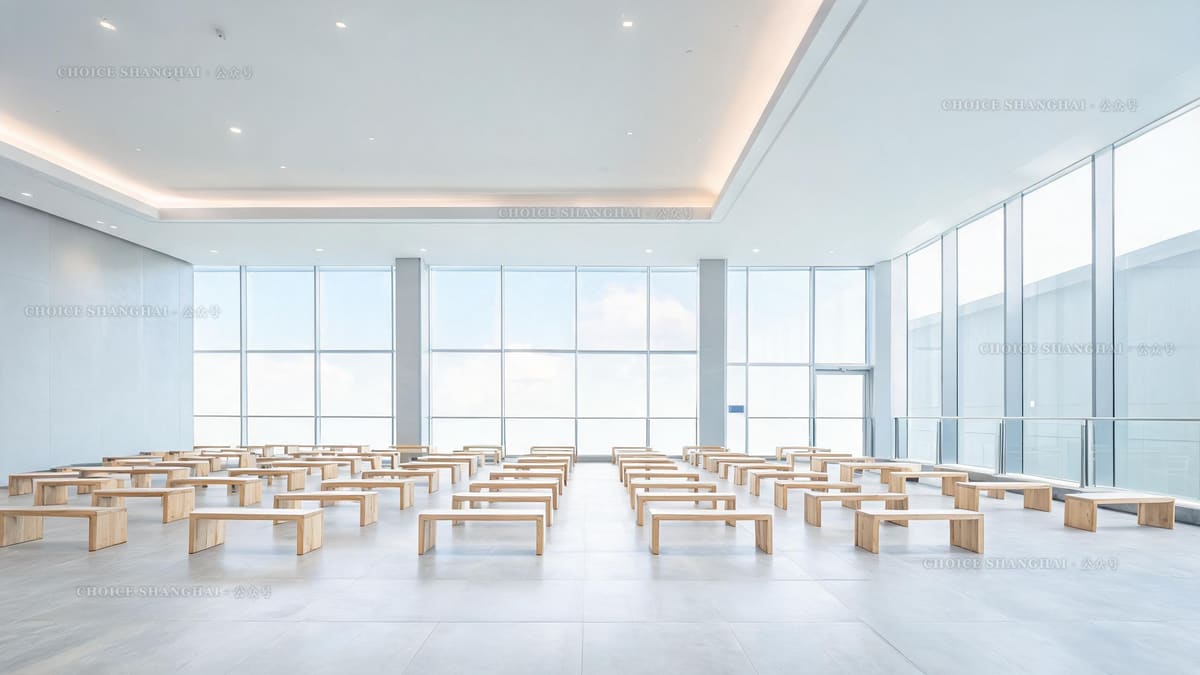 A bright, orderly modern government service hall in Shanghai with empty pale-wood waiting benches and tall glass walls