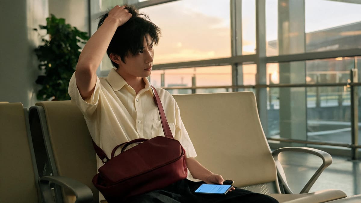 A stranded traveller waiting overnight in a Shanghai airport terminal after a typhoon flight cancellation