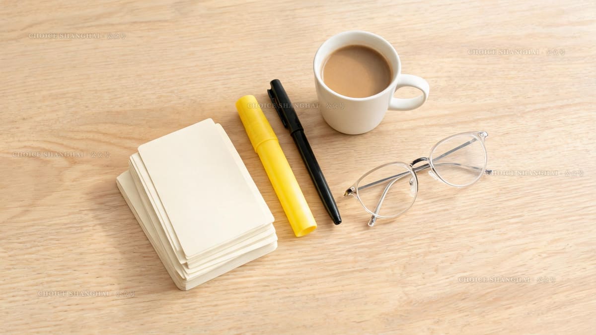 A study desk from above with a stack of blank flashcards, a highlighter, a pen and a mug of coffee for Chinese exam prep
