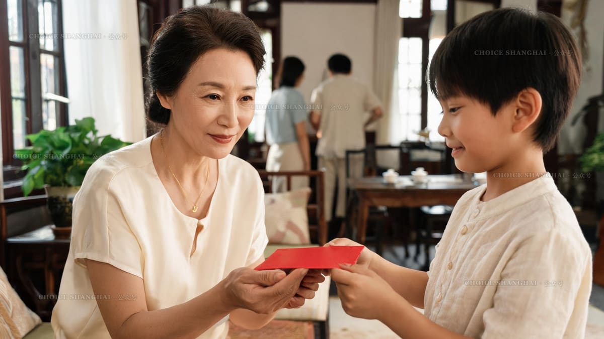 A grandmother giving a red lucky envelope to a young boy with both hands at a warm Shanghai family gathering