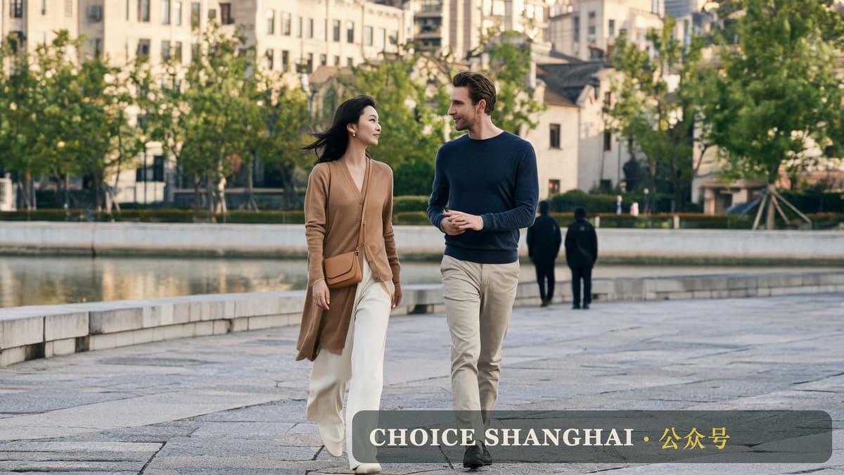 Two friends walking and talking along a Shanghai riverside promenade in autumn