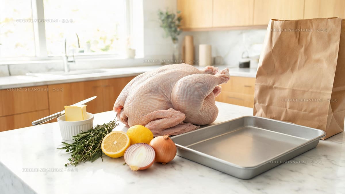 A raw whole turkey on a kitchen counter with butter, herbs, lemons and a roasting tray, ready to cook at home