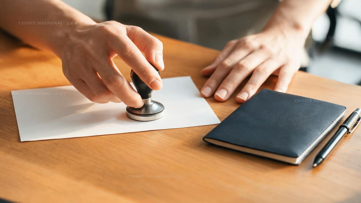 Hands stamping and signing an official document beside a passport, the notarial service a Shanghai consulate provides