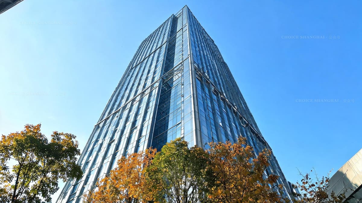 A modern glass office tower in downtown Shanghai on a bright autumn day, where many consulates keep their offices