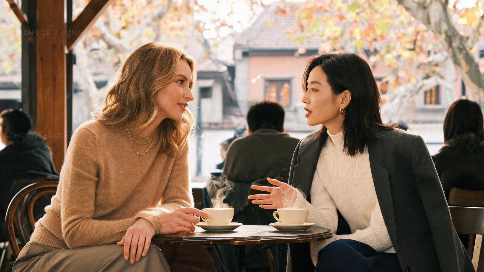 Two friends talking warmly over tea in a cosy Shanghai cafe in autumn, the kind of real connection that helps with burnout