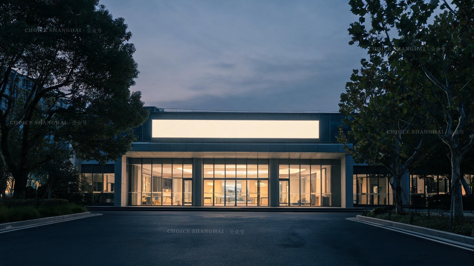 A modern clinic entrance lit warmly at dusk with a calm empty driveway, the kind of place you navigate in a crisis with consular support