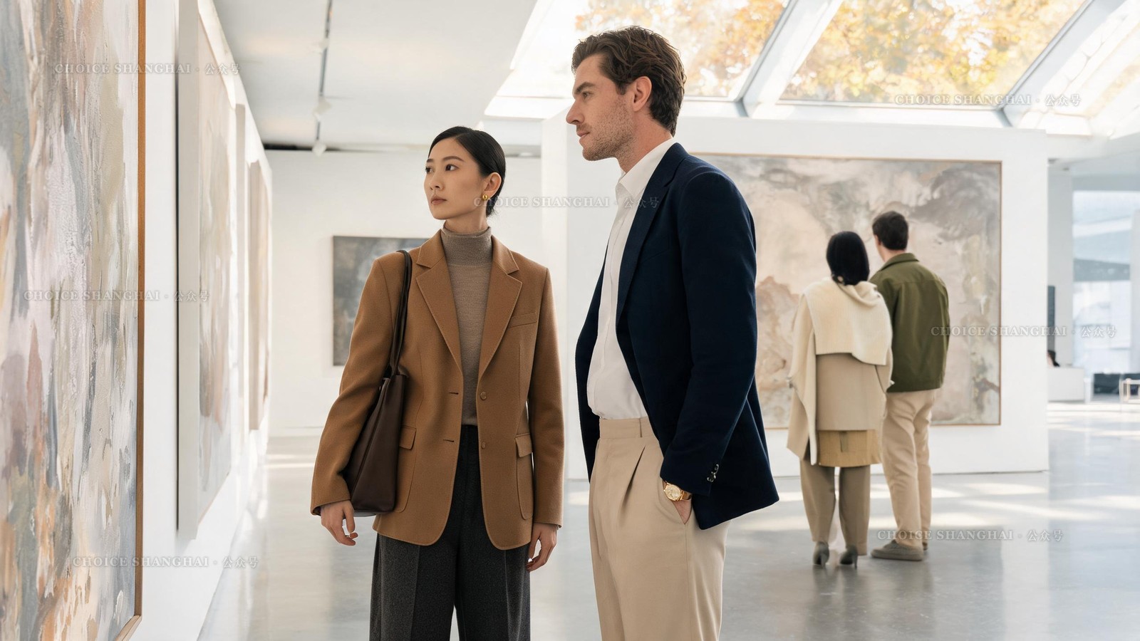A couple viewing large abstract paintings in a bright airy contemporary art gallery in Shanghai, high ceilings and daylight