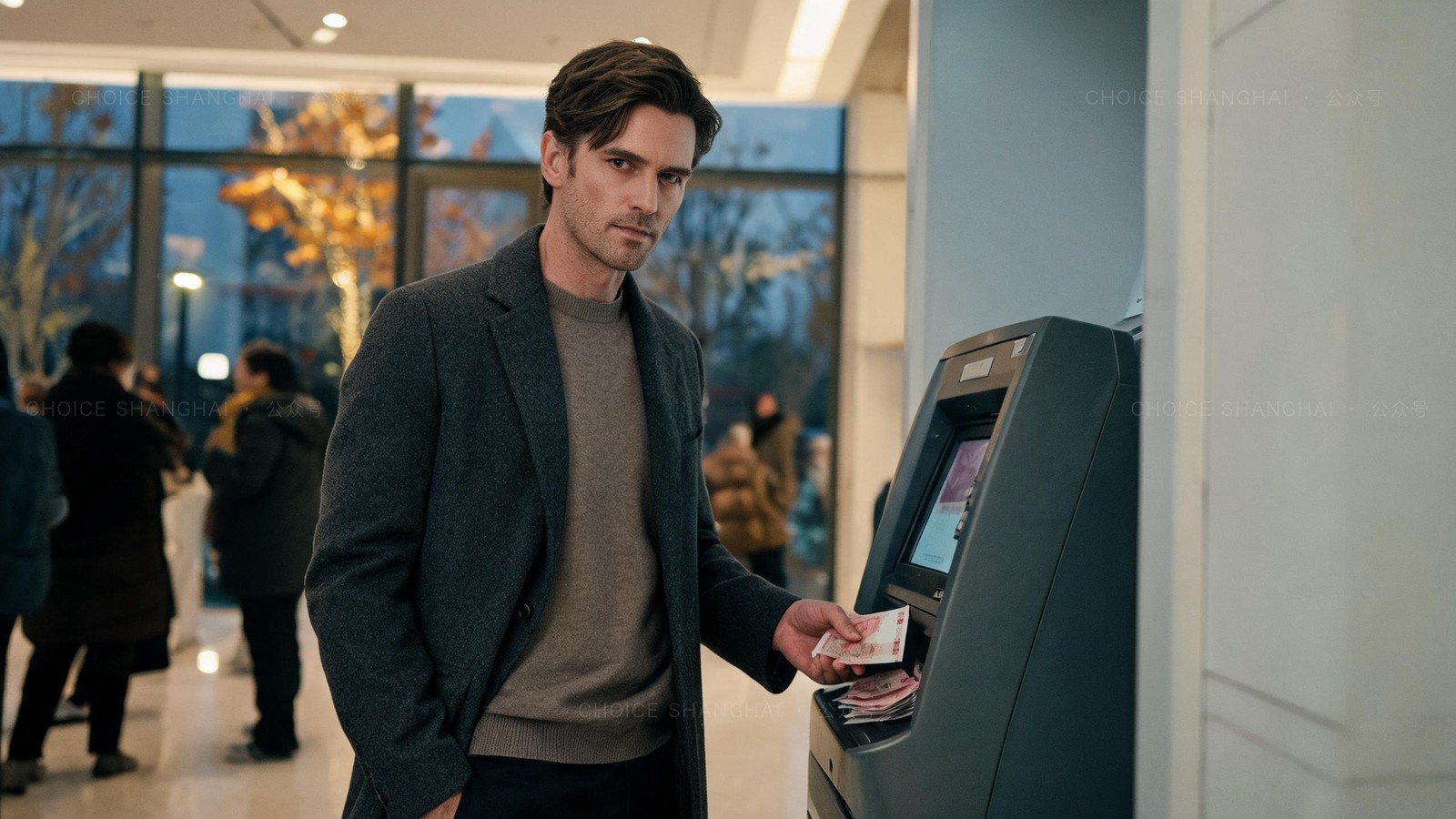 A man in a charcoal overcoat withdrawing yuan notes from a Bank of China ATM in a bright Shanghai bank lobby in the evening