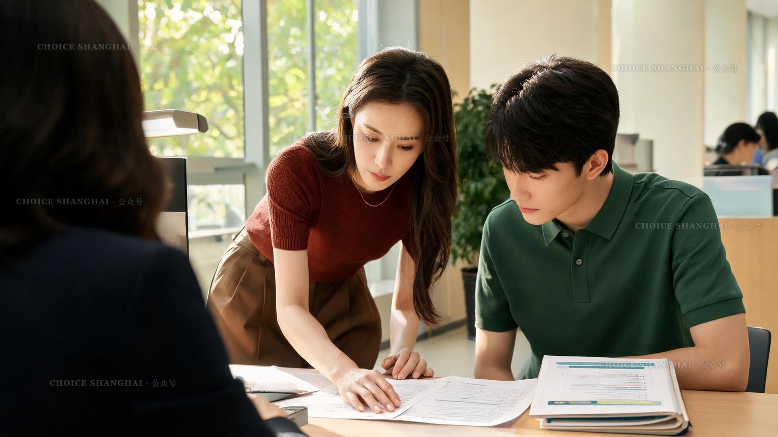 Teenage applicant and her mother reviewing transcripts with an admissions officer at a Shanghai international school