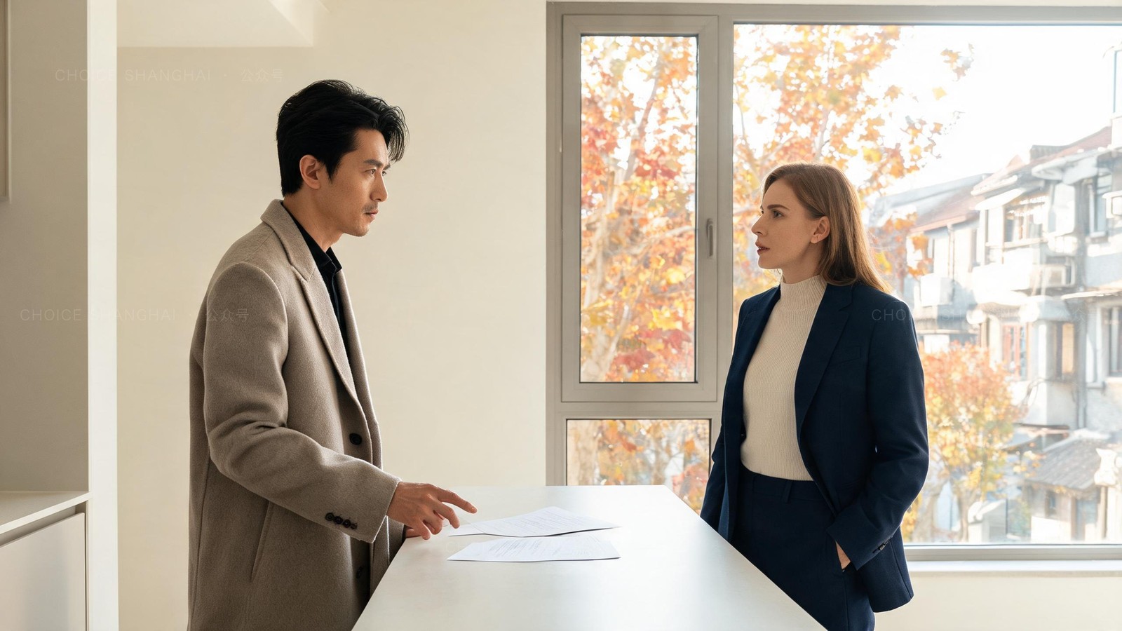 A man in a stone overcoat discussing lease terms with an estate agent in an empty bright Shanghai apartment, papers on the counter