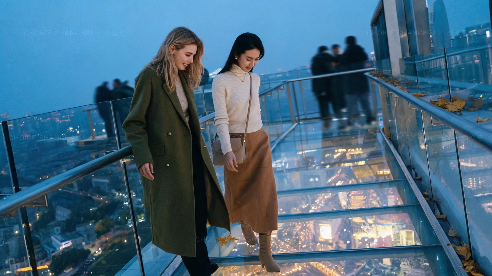 Two women on a glass-floored observation skywalk high above Shanghai at blue hour, looking down at the glowing streets far below