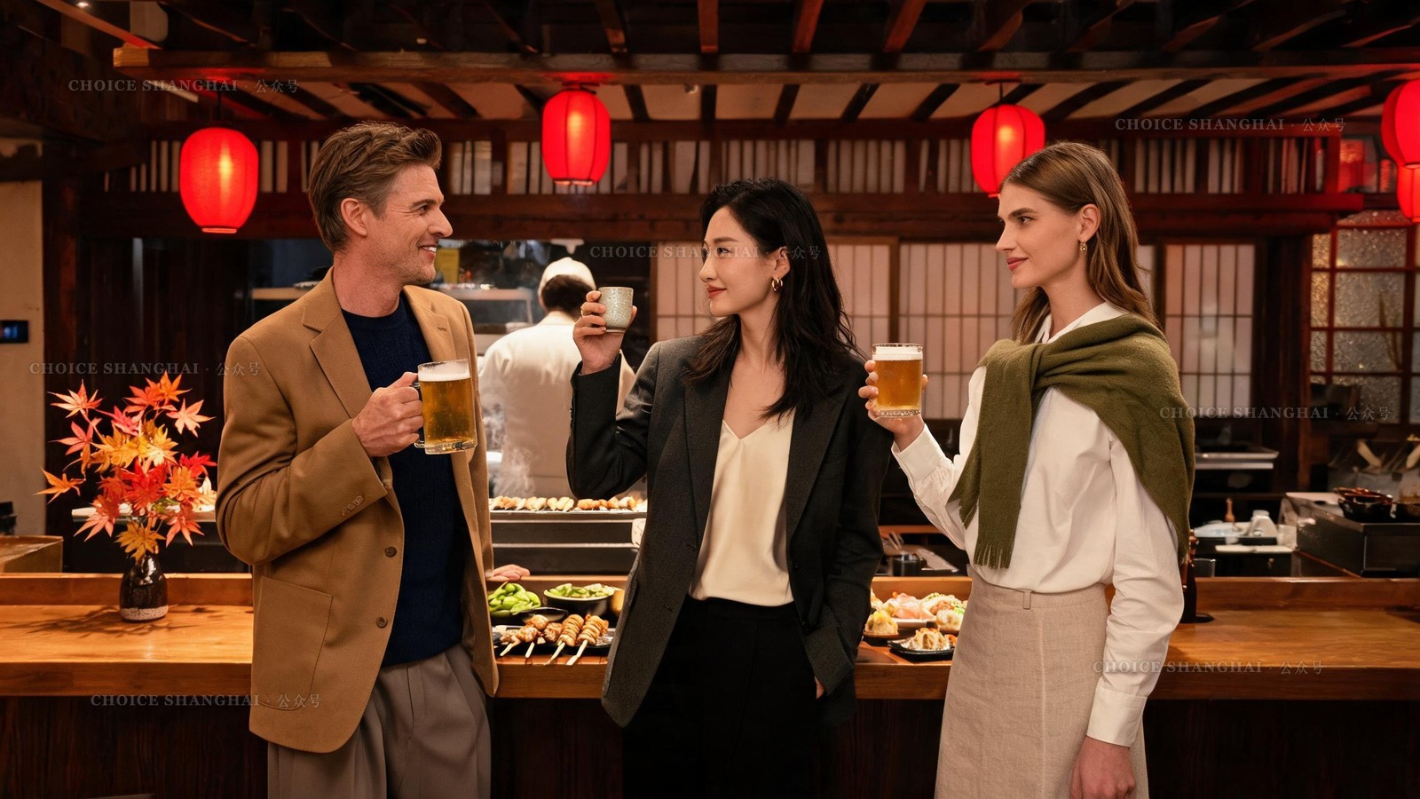 Three friends raising beer and sake at a lively Japanese izakaya counter in Shanghai with red lanterns and a grill behind