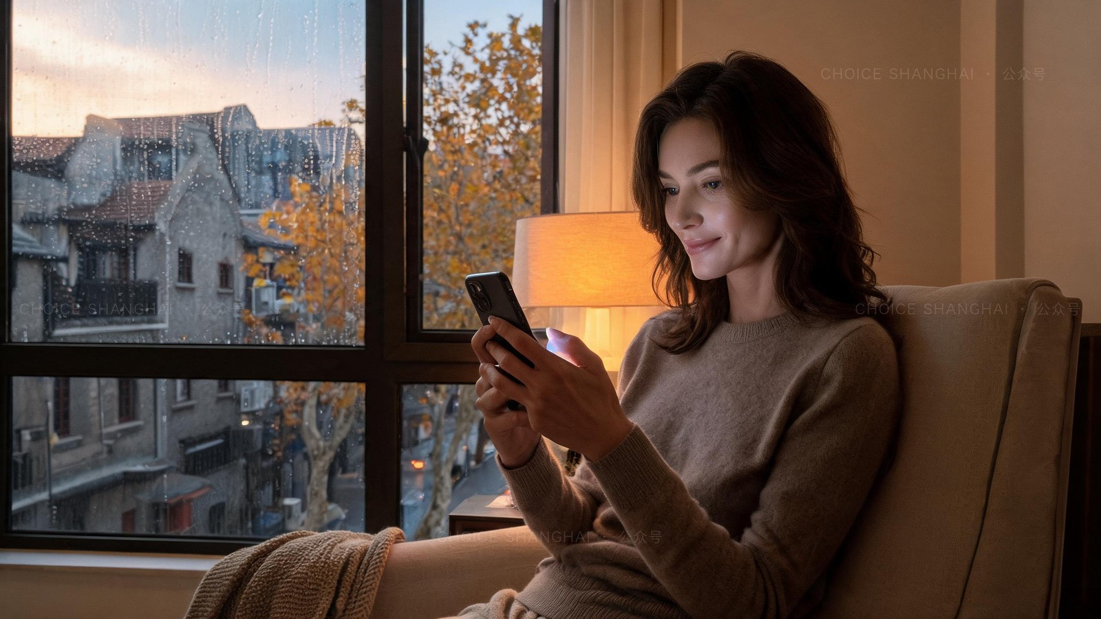A woman in a soft knit by a rain-flecked window at dusk, lit by a video call on her phone in a warm Shanghai apartment