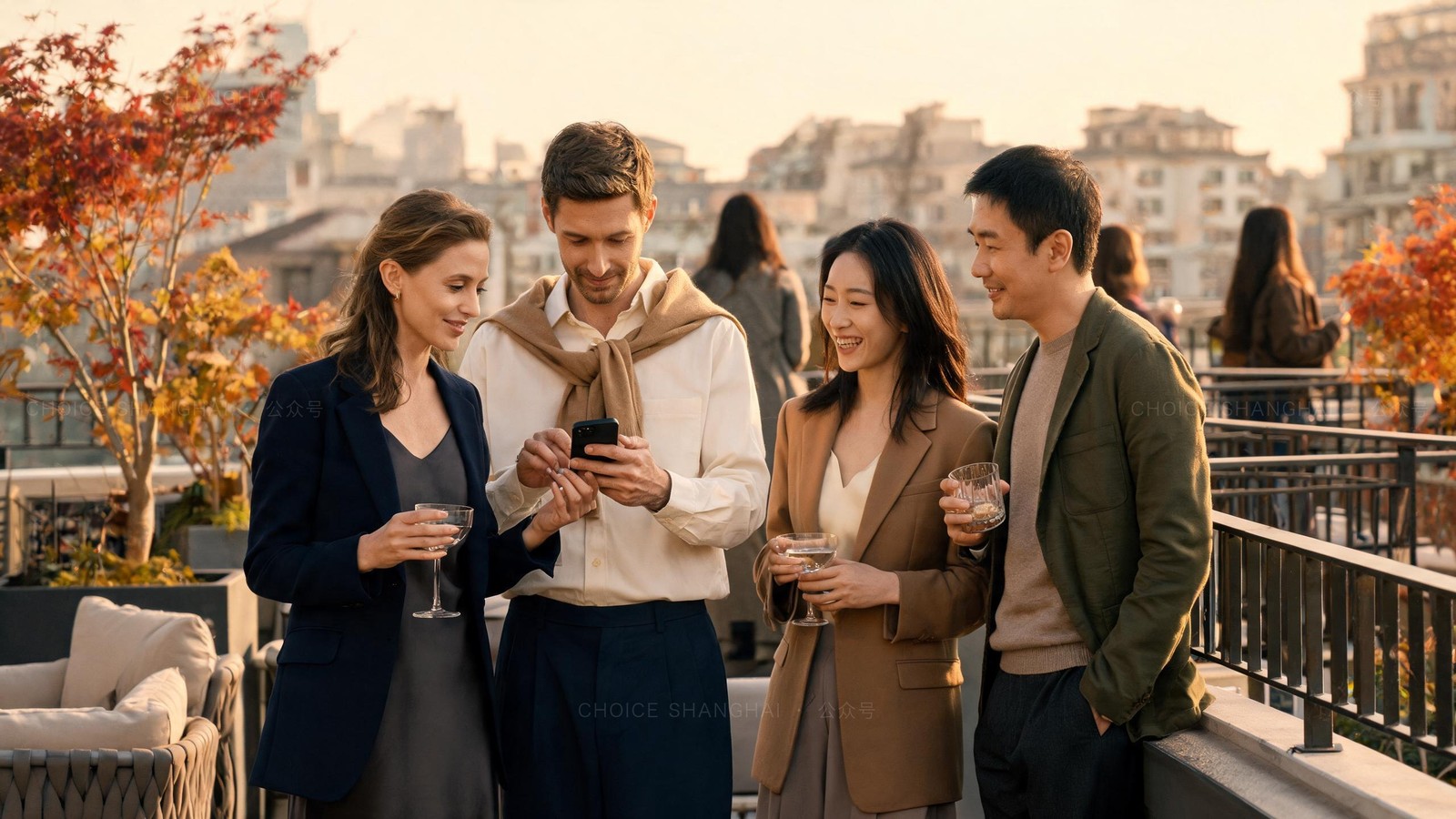 Four international and local professionals at a golden-hour Shanghai rooftop mixer, two holding phones together to swap contacts