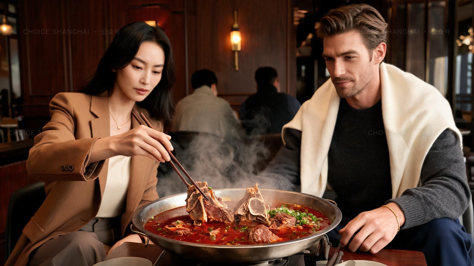 A steaming lamb-spine hotpot in deep red broth with scallions on a Shanghai restaurant table, two diners lifting lamb on the bone with chopsticks