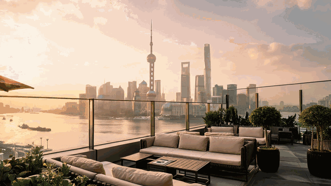 A reel of Shanghai date rooftops from golden hour into the night, terrace tables and lounges with the Pudong skyline glowing across the river