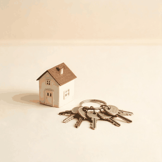 A model house on a stack of paperwork with a stamp and a price tag