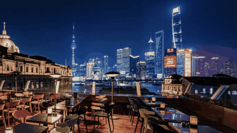 The Captain's rooftop and the colourful Pudong skyline lit up at night, one of Shanghai's dinner-with-a-view rooms