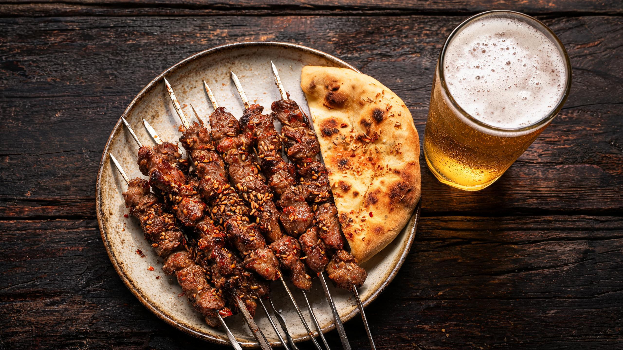 A plate of Xinjiang lamb skewers and naan at a late-night Shanghai barbecue restaurant